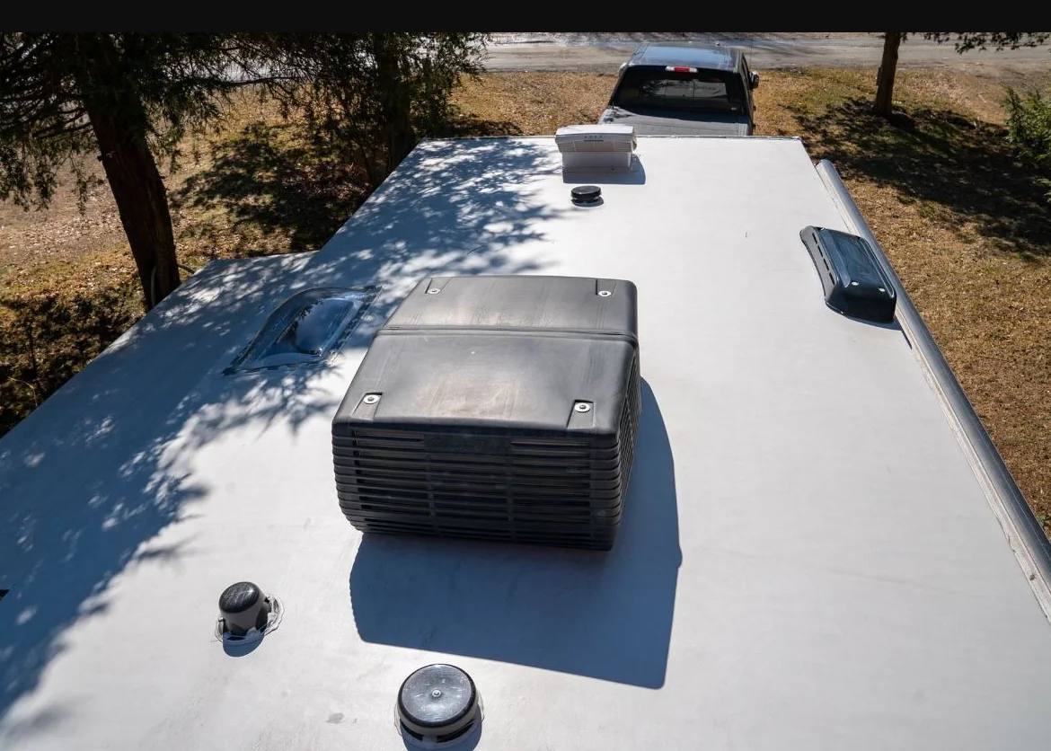 Rooftop AC repair on an RV in Florida summer heat