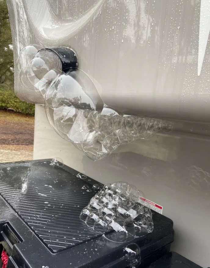 Black tank repair underneath a fifth wheel